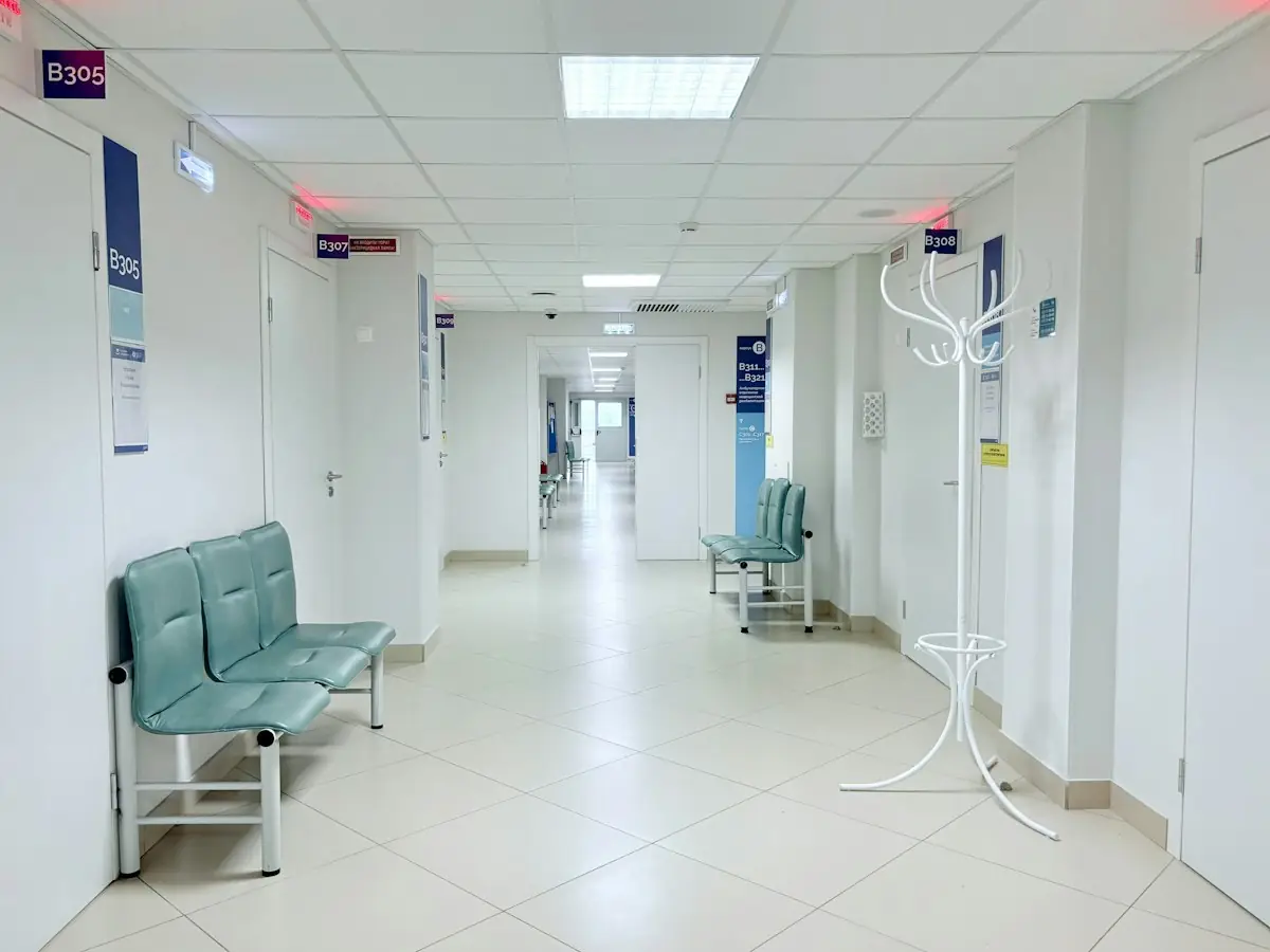 An empty hospital corridor with benches