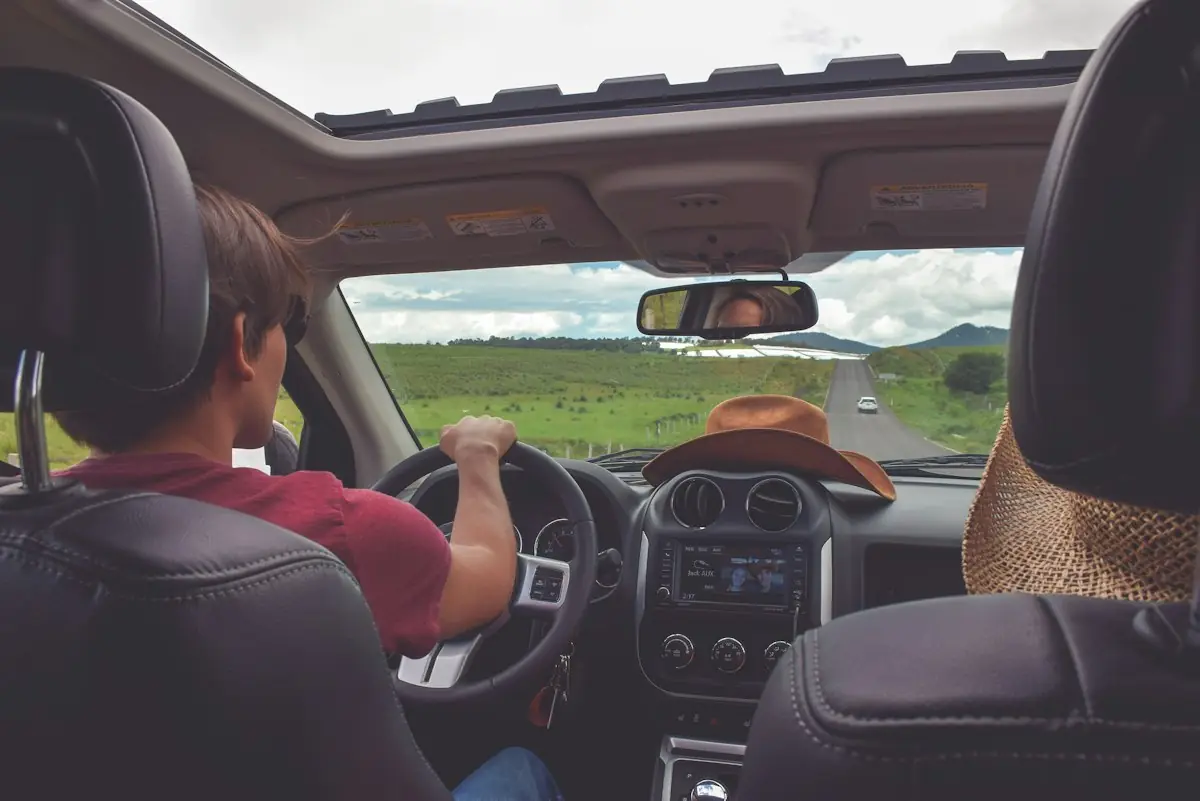 A family on a road trip, seen from the back seat