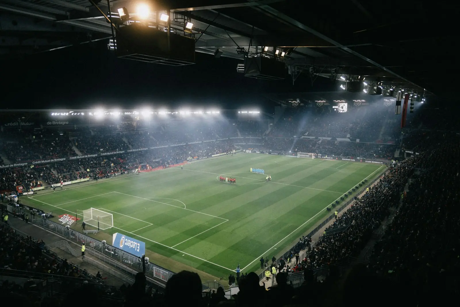 A floodlit football stadium at night
