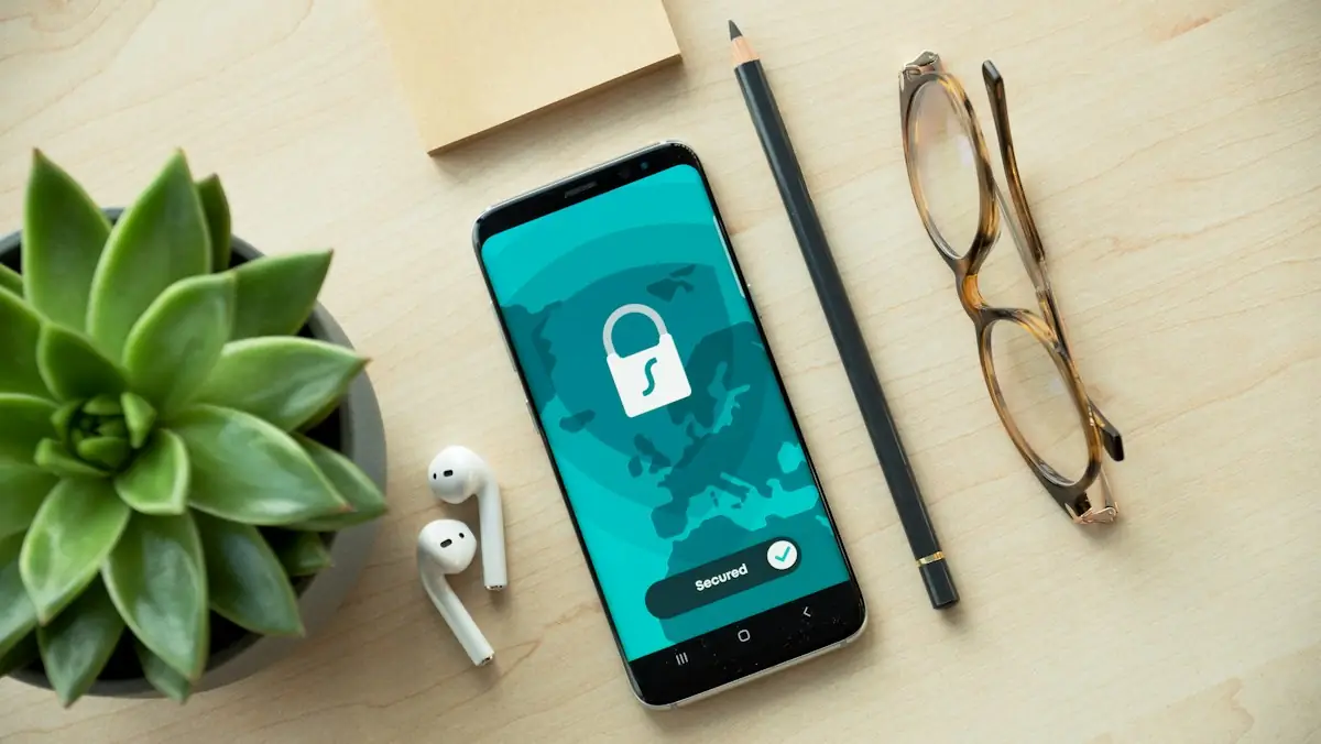 A phone showing a security lock on a wooden desk