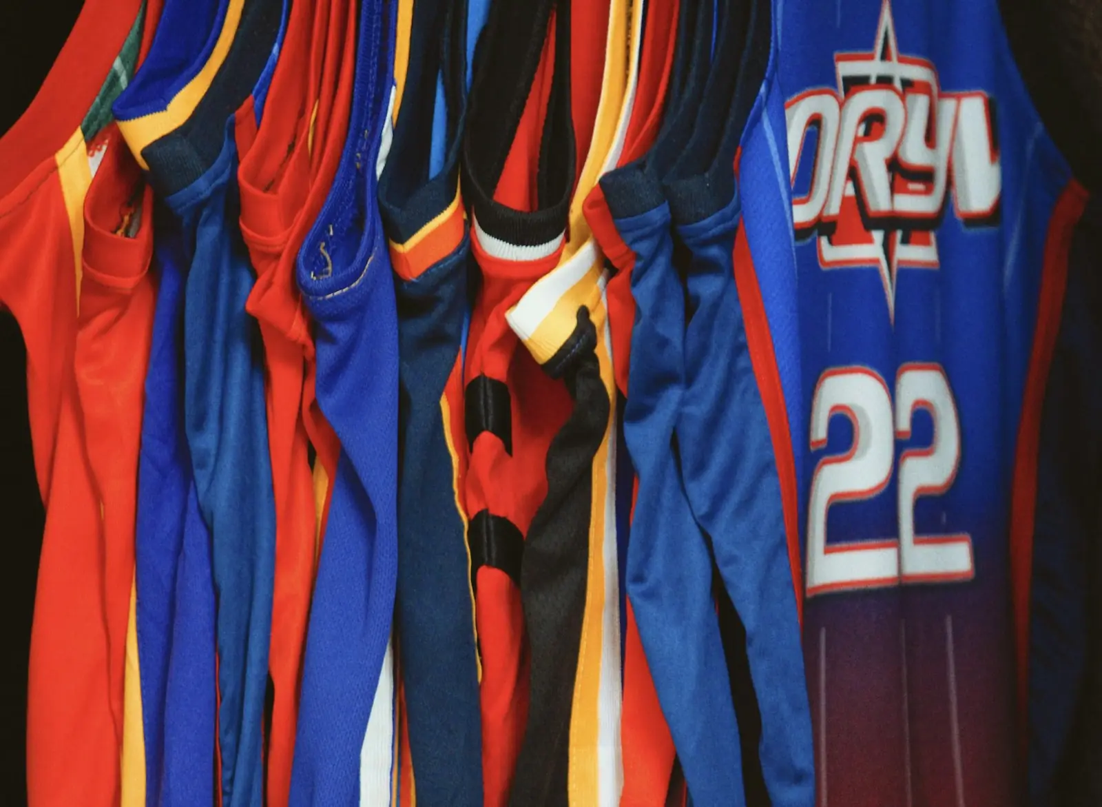 Sports jerseys in team colours hanging on a rack