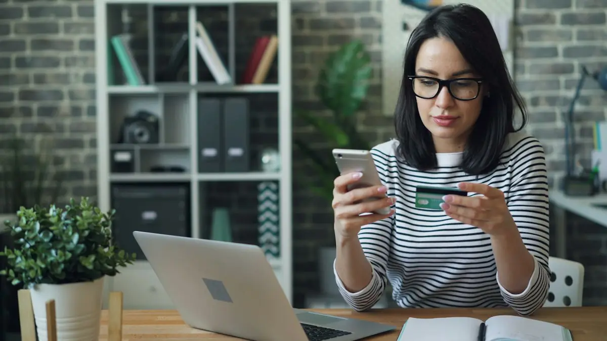 A woman paying online with a card at her laptop