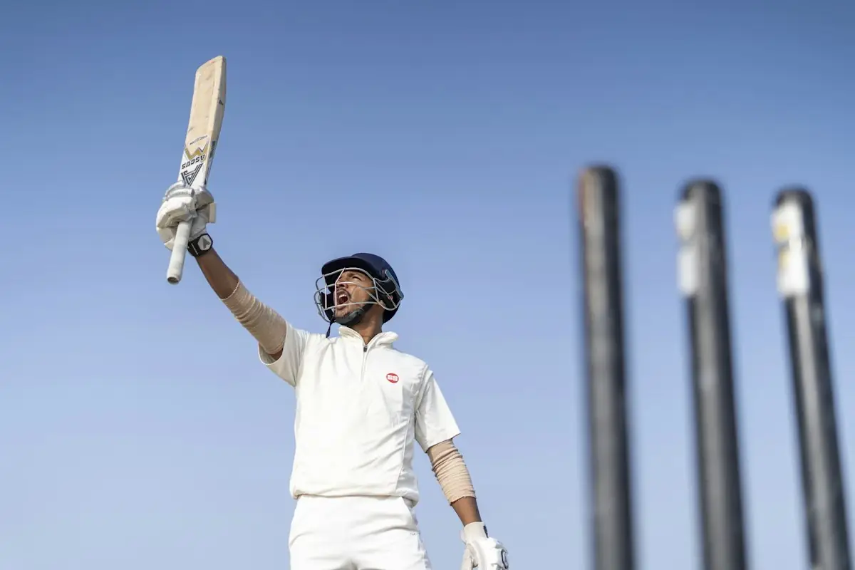 A batsman raising his bat to the crowd