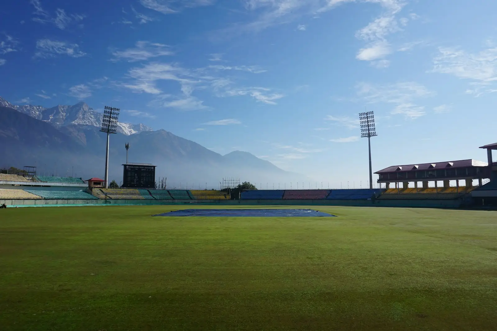 A cricket ground beneath the mountains
