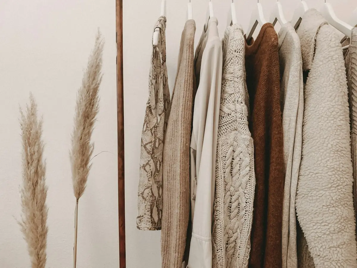 Neutral knitwear hanging on a clothing rail