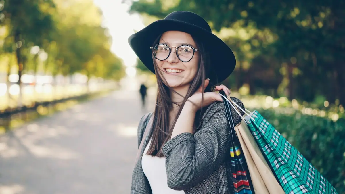A smiling woman carrying shopping bags in a park
