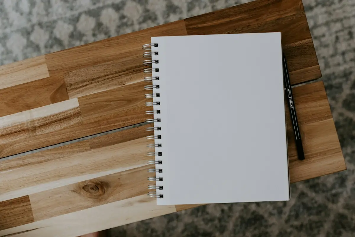 A blank spiral notebook on a wooden table