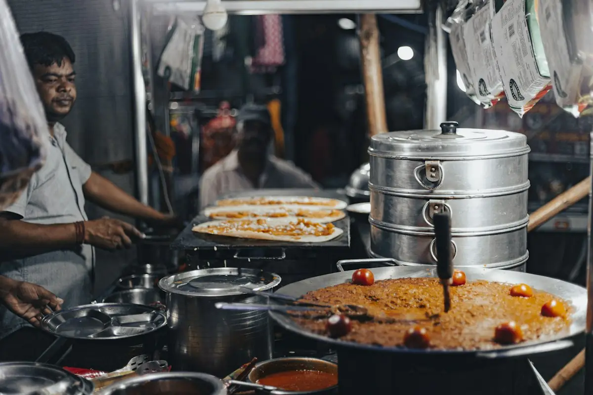 Street food being cooked at a stall at night
