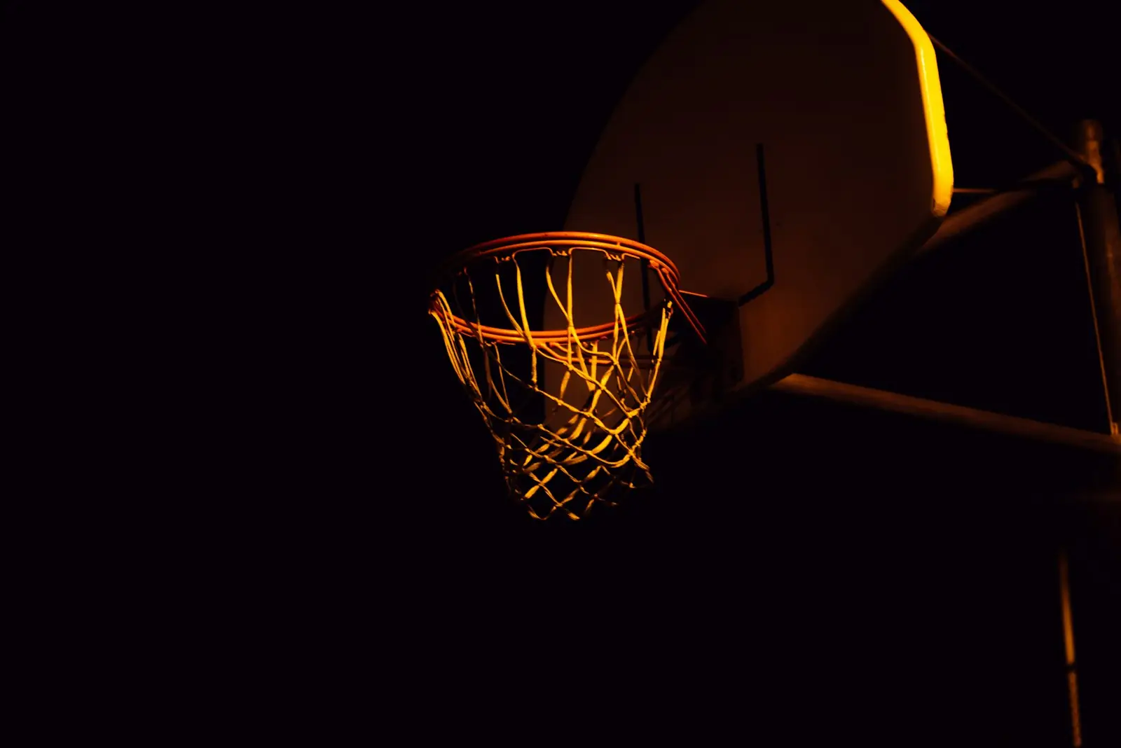A basketball hoop lit up at night