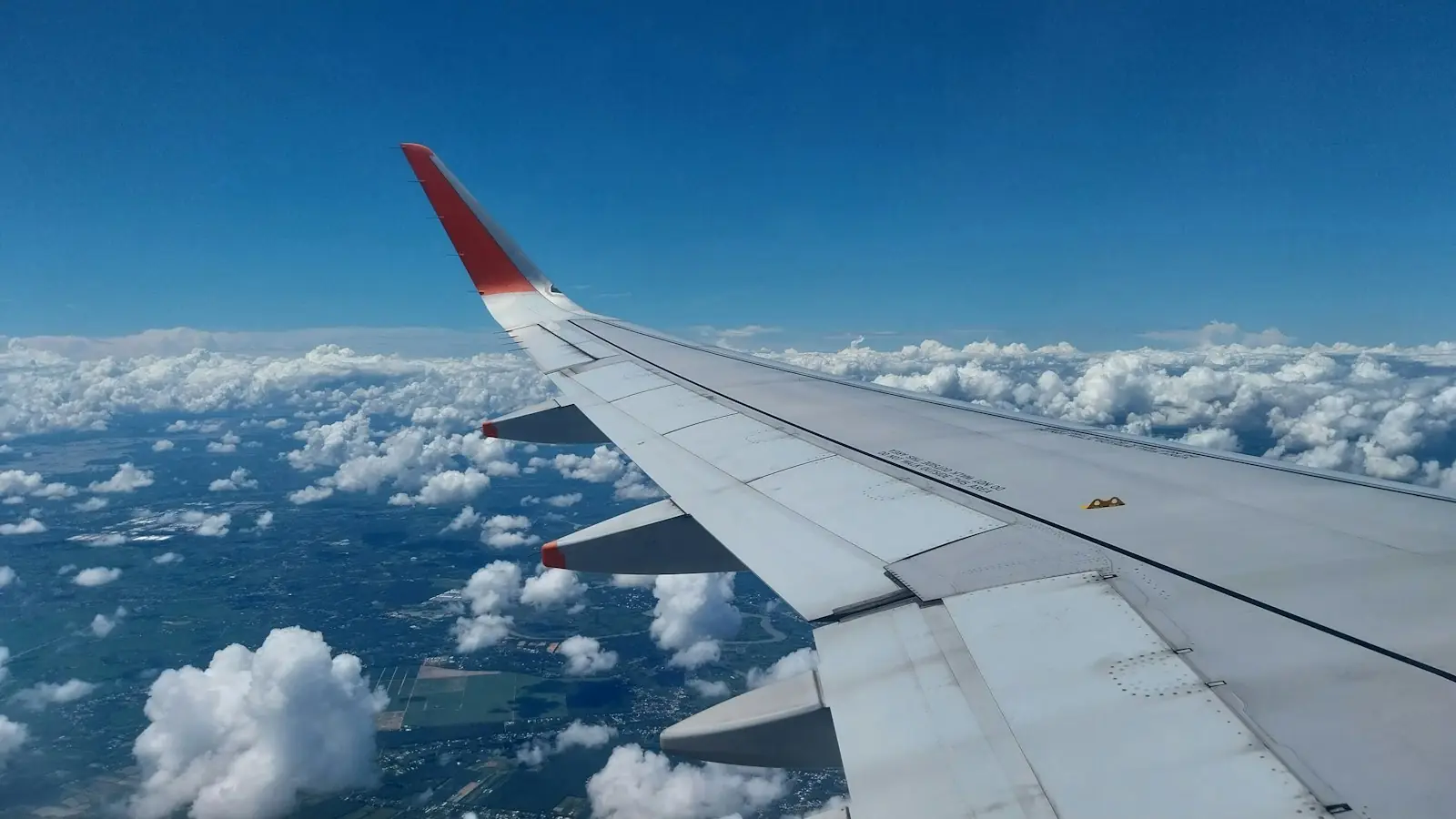 An airplane wing above the clouds