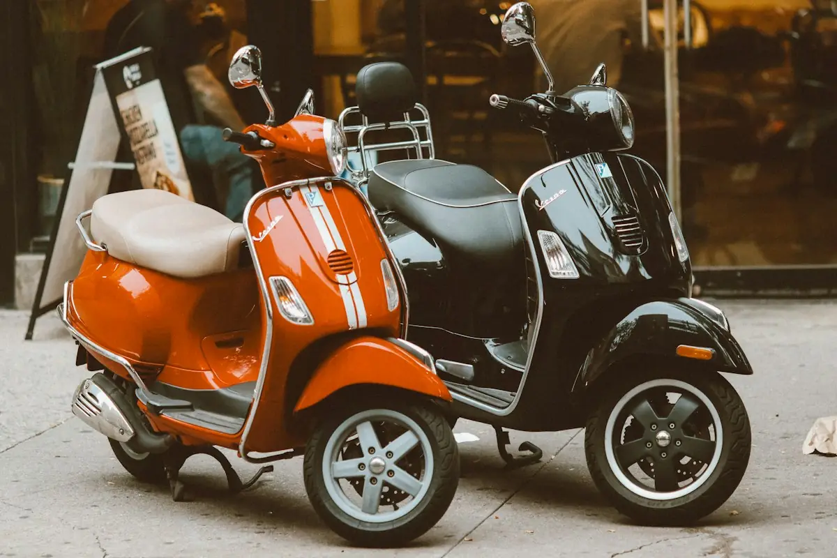 Orange and black scooters parked on the street