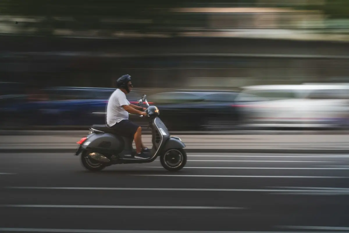 A rider on a scooter speeding through the city