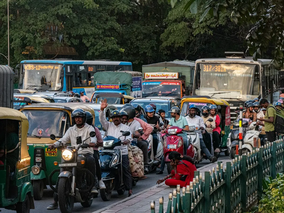 Scooters, auto-rickshaws and buses in Indian city traffic
