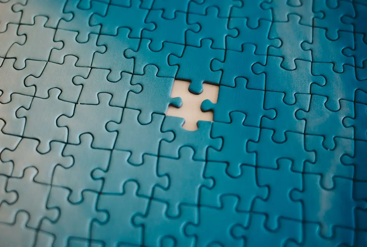 A blue jigsaw puzzle with one piece missing