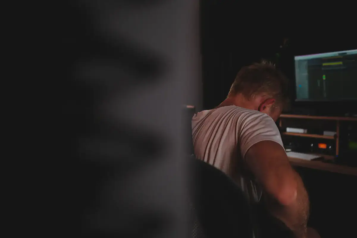 An analyst working at a desk in a dim room